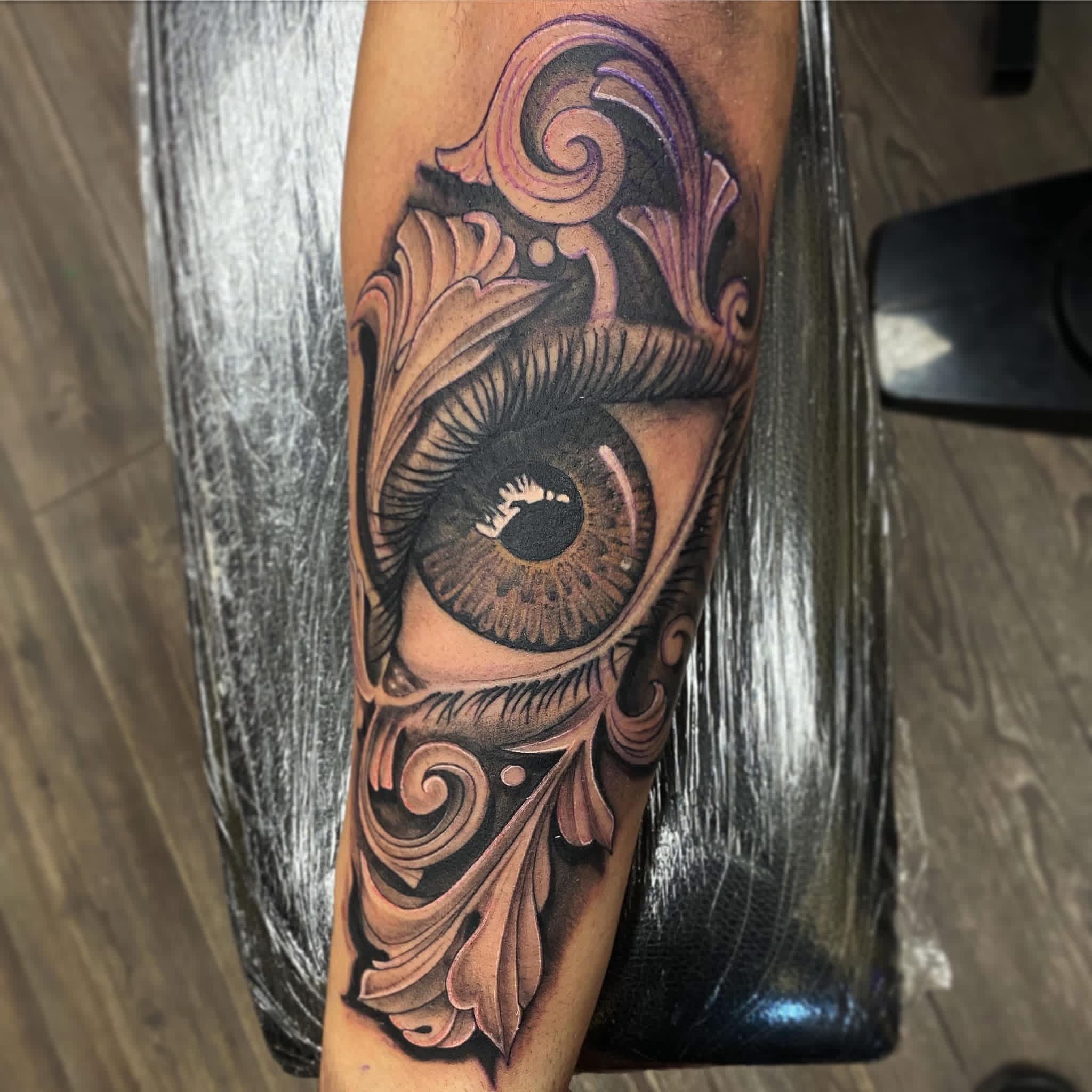Realistic eye with ornamental filigree tattoo by Stax